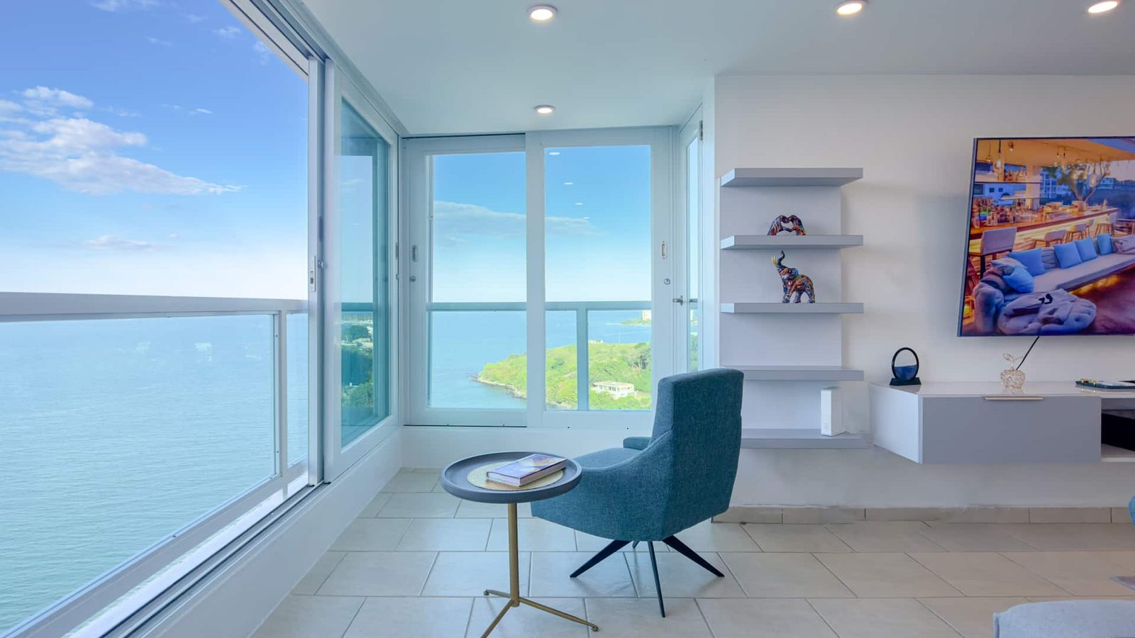 Turquoise Horizons interior — corner sitting area with floor-to-ceiling ocean views